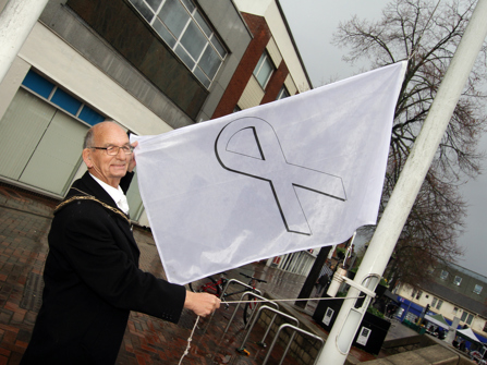 The Mayor of Broxtowe raising the white ribbon flag