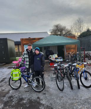 A Stapleford resident with a RideWise mechanic with bikes