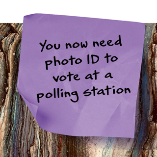 A sticky note reading 'You now need photo ID to vote at a polling station'