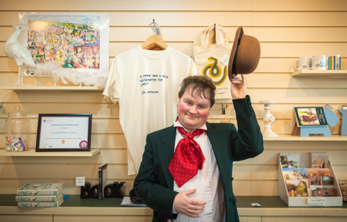 A museum employee greeting guests at an event at the museum