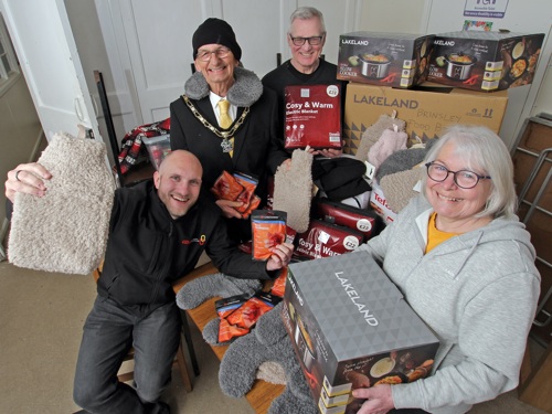 The Mayor of Broxtowe with two foodbank volunteers and EEM representative with hot water bottles, slow cookers, electric blankets.