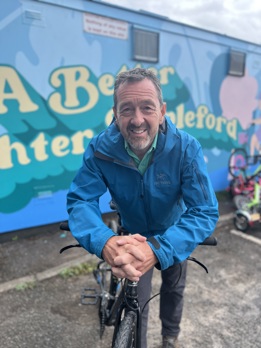 Chris Boardman stood next to a bike in front of Stapleford's cycle hub