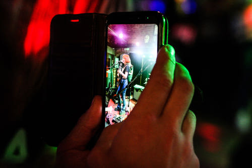 A visitor records a performer at last year's D.H. Lawrence Music Festival