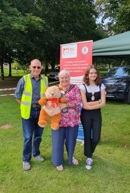 The Mayor of Broxtowe with two people at the fair holding a teddy bear