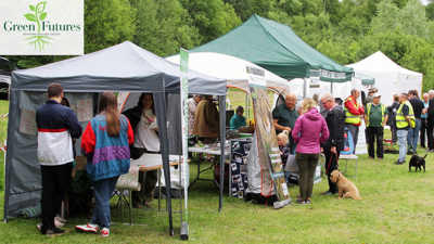 A crowd of people looking at stalls
