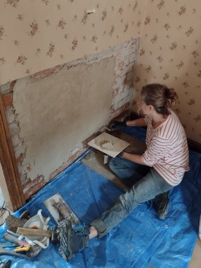 A volunteer applying a first coat for plasterwork at the D.H. Lawrence Birthplace Museum