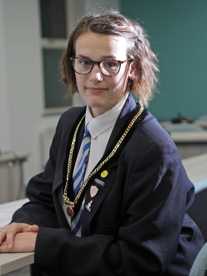 Millie Richards Broxtowe Youth Mayor, sat with brown hair, wearing glasses and the youth mayor chain