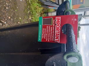 Contamination tag on green-lidded recycling bin