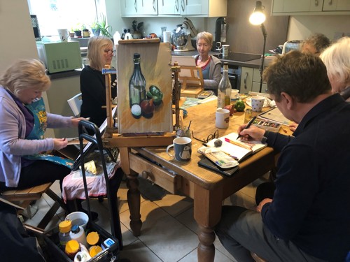 The Monday Art Group painting round a table