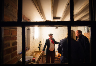 A man dressed in Victorian attire giving a tour of the D..H Lawrence Birthplace Museum