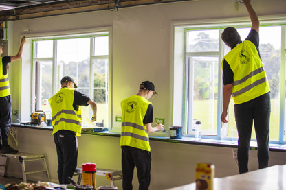 Volunteers painting the Beeston Casuals clubhouse
