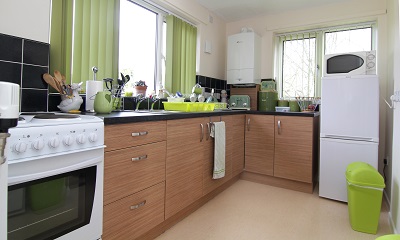 Modernised Kitchen with green curtains