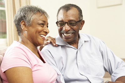 Older couple laughing together in their living room