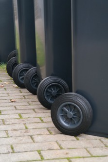 Row of black wheelie bins