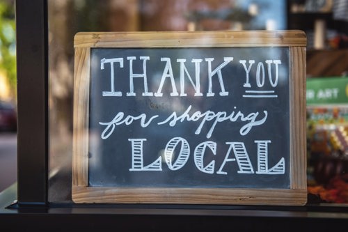 black board saying 'thank you for shopping local'