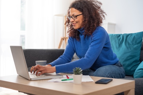 woman on her laptop, smiling