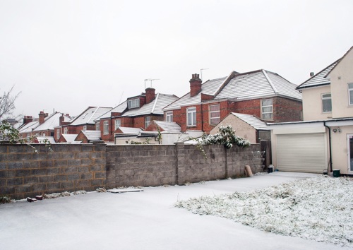 Terraced red brick houses covered in snow