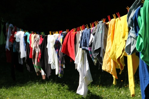Washing line with lots of coloured clothes pegged up