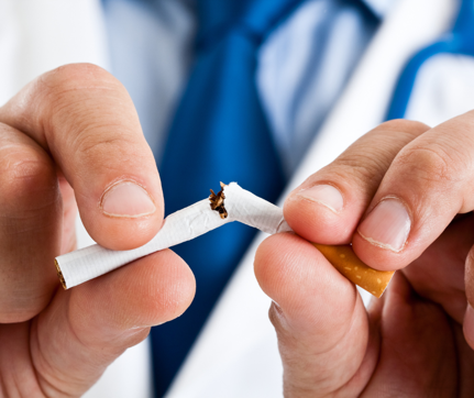 A man breaking up a cigarette