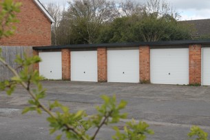 Landscape view of ghosthouse garages in broxtowe. With branch in front.
