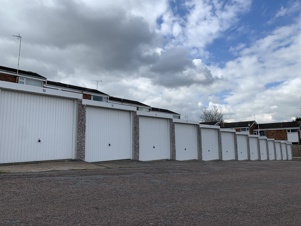 a landscape picture of griesdale court garages, with fluffy clouds above