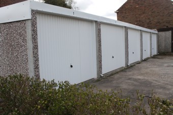 Lark close garages with green bush infront