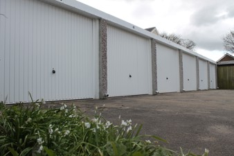 side of wheatgrass garages with flowers in front