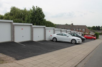 marriott garages - 12 garages with white doors and cars parked outside a few garage doors