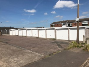 Sunny day at ulldale garage - a row off building with white doors