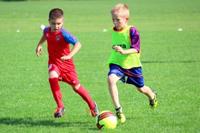 Two children playing football