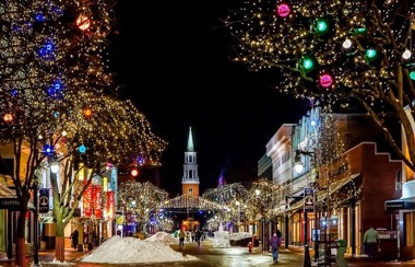 A town centre with snow and lit up in Christmas lights A town centre with snow and lit up in Christmas lights