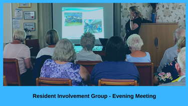 Resident Involvement evening meeting - tenants sitting together watching a presentation