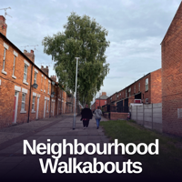 people walking down a housing street