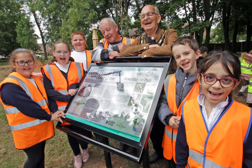 The Mayor and schoolchildren with the new information board at the Pocket Park