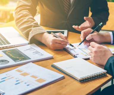 2 people talking through business graphs
