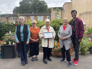 Group smiling holding certificate