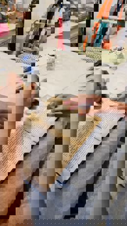 A book being carefully cleaned at the D.H. Lawrence Birthplace Museum