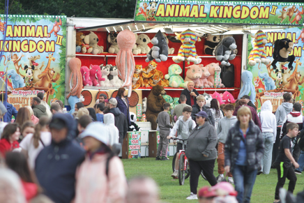 People in front a fairground ride at Hemlock Happening