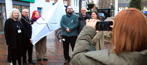 Representatives from Broxtowe Women's Project and Broxtowe Mayor, Councillor Robert Bullock raising the white ribbon flag in Beeston