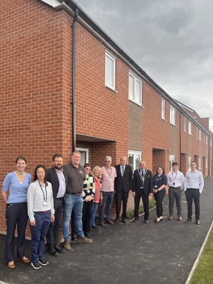Officers and councillors outside the new properties at Inham Nook