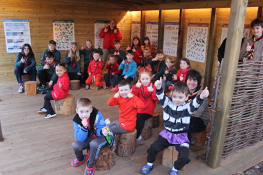 Children sitting in the outdoor learning area
