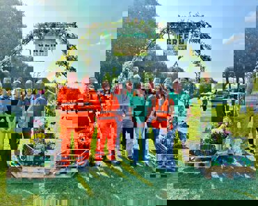 Broxtowe employees under a Green Festival arch made of plants