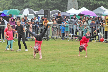 A dance group doing cartwheels