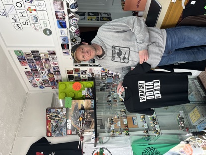 Lee in his shop with a tshirt that says straight outta Kimbo