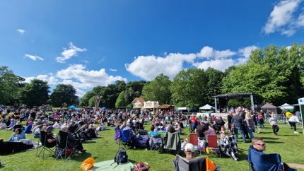 Hemlock Happening 2024, groups sitting on the grass in front of the main stage