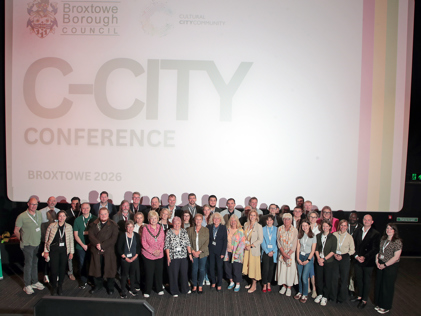 The C-City group in front of a cinema screen that reads: C-City conference Broxtowe 2026